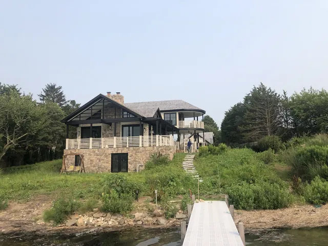 Waterfront home with stone base