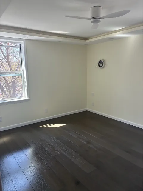Finished bedroom with dark hardwood floors