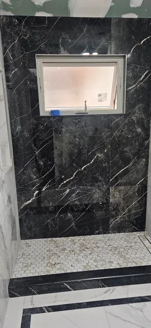Black marble-look tile with banded floor