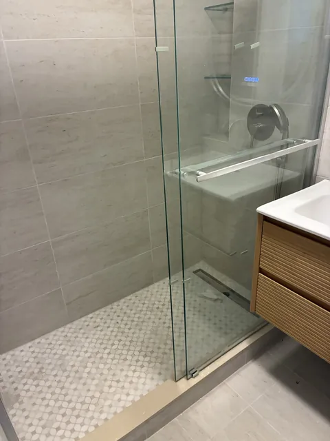 Frameless glass shower with mosaic floor